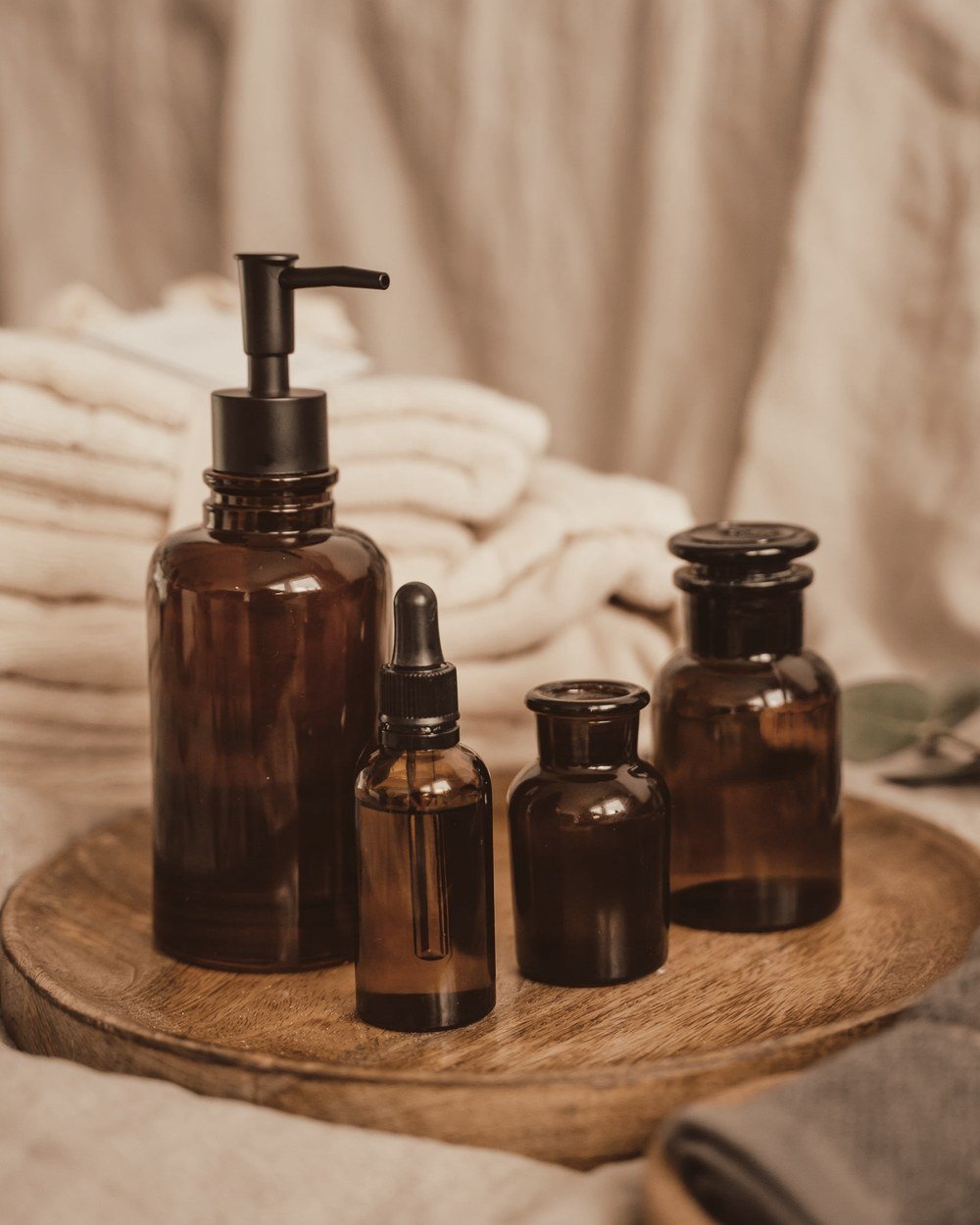 Amber glass dispensary bottles on a wooden tray